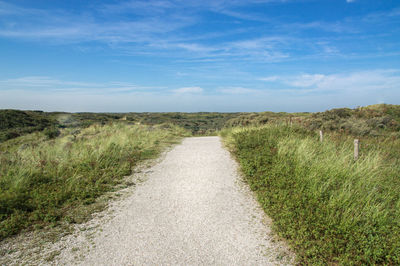 Empty road along countryside landscape