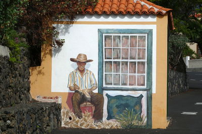 Portrait of man in house against building