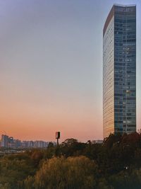 Modern buildings against clear sky at sunset