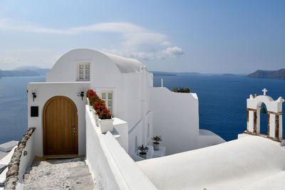 Building by sea against sky