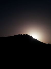 Silhouette mountain range against clear sky during sunset