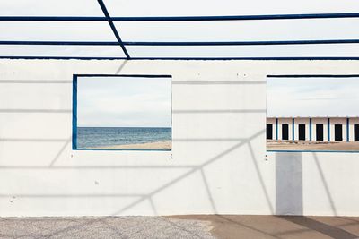 Sea against sky seen through window