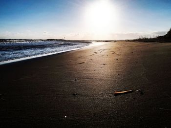 Scenic view of beach against sky during sunset