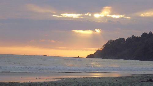 Scenic view of beach against sky during sunset