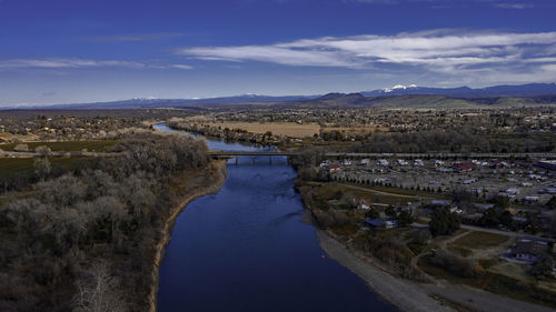 High angle view of river amidst city against sky