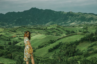 Portrait of man standing on mountain landscape