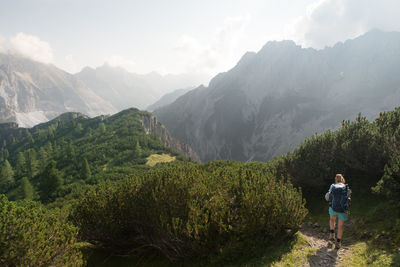 Rear view of woman hiking on mountain