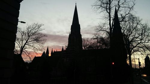 Low angle view of building against sky at sunset