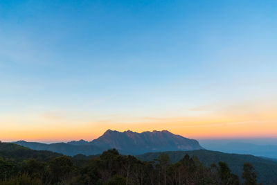 Scenic view of mountains against sky during sunset