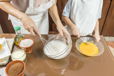 Midsection of woman holding food on table