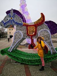 Full length of girl standing against wall