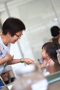 Close-up of woman holding girl's hand