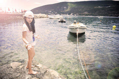 Portrait of young woman standing in sea