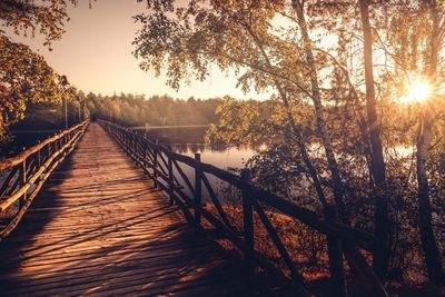 Boardwalk over lake during sunny day