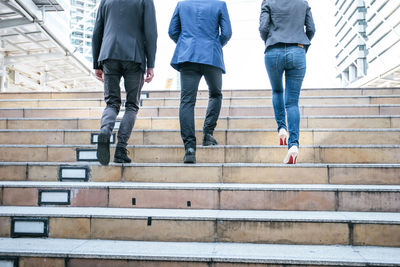 Low section of women walking on staircase