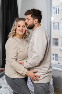 Happy young couple standing outdoors