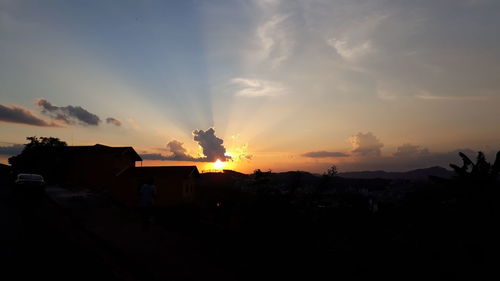 Silhouette buildings against sky during sunset