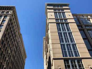Low angle view of buildings against blue sky