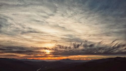 Scenic view of landscape against cloudy sky