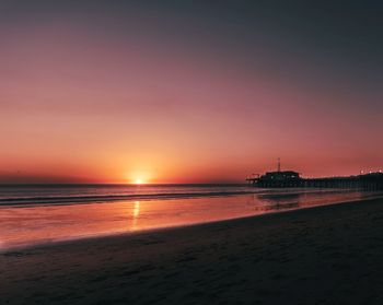 Scenic view of beach against sky during sunset