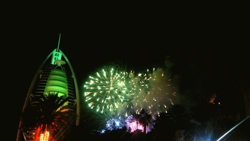 Low angle view of firework display at night