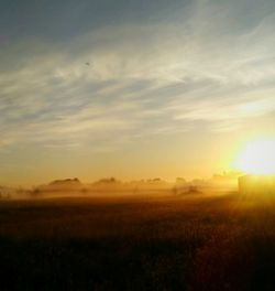 Scenic view of field against sky during sunset