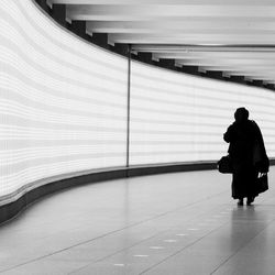 Full length of woman standing by railing