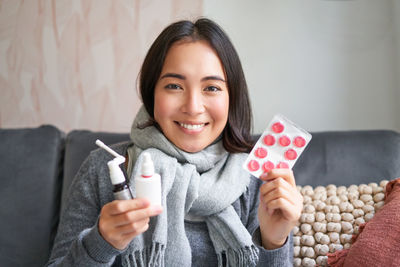 Portrait of young woman using mobile phone