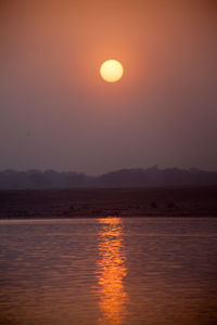 Scenic view of lake against romantic sky at sunset