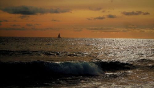 View of sea against cloudy sky during sunset