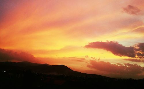 Scenic view of silhouette mountains against sky during sunset