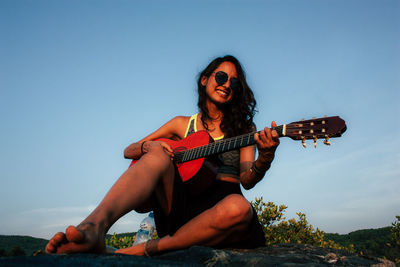 Portrait of young woman sitting outdoors