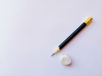 High angle view of colored pencils against white background