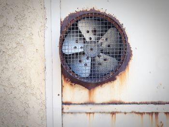 Close-up of rusty metal against wall