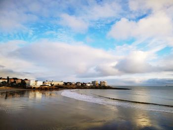 Scenic view of sea against sky in city