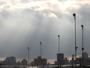 Street lights against sky in city