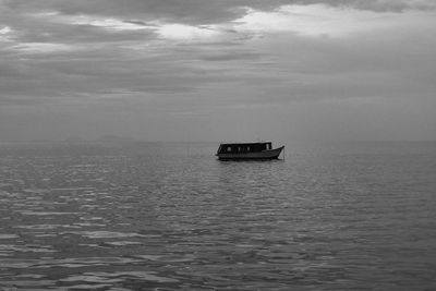 Boat sailing on sea against sky