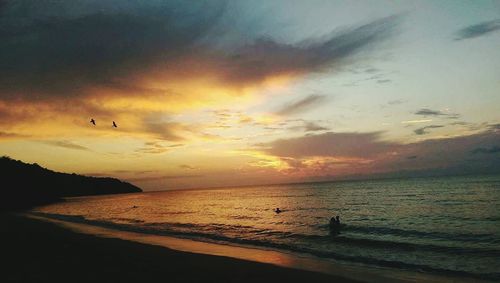 Scenic view of sea against dramatic sky