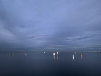 Scenic view of sea against sky at dusk