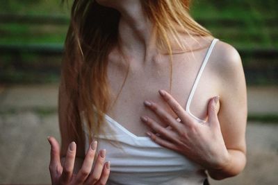 Midsection of woman standing against blurred background