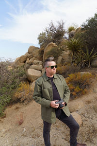 Portrait of young man standing on field