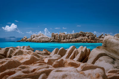 Panoramic shot of sea shore against blue sky