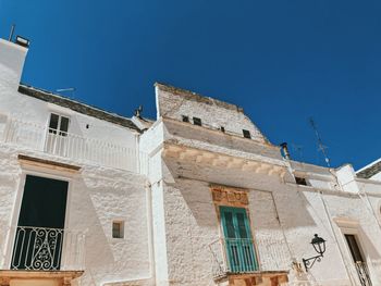 Low angle view of old building against blue sky