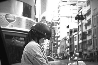 Portrait of woman with cars in city