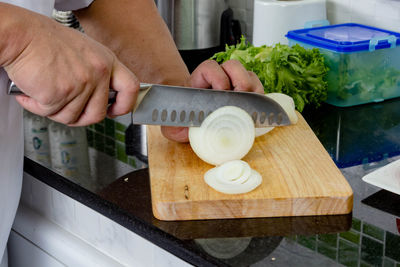 Midsection of man preparing food in kitchen