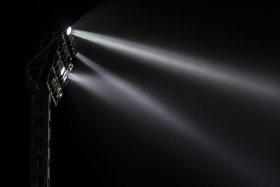 Low angle view of illuminated lights against sky at night