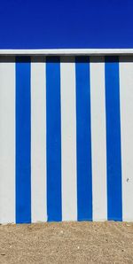 Blue pattern on wall against clear sky