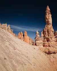 Low angle view of rock formation against sky