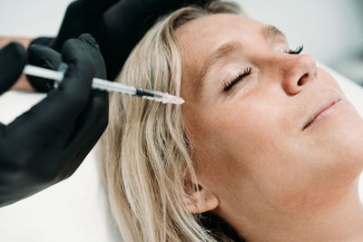 Young woman gets beauty facial injections in salon or clinic. skincare concept