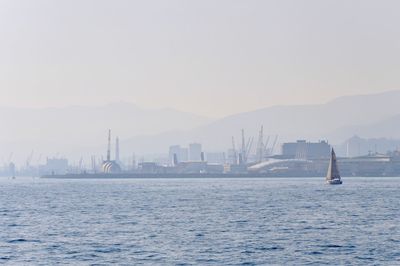 Scenic view of sea and buildings against clear sky